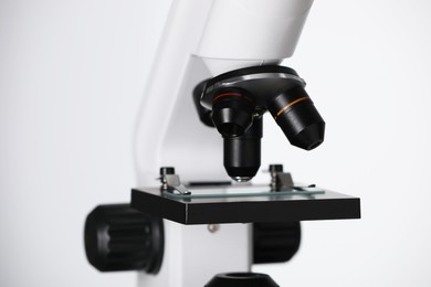 Modern microscope on light background, closeup. Medical equipment