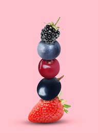 Image of Stack of different fresh tasty berries and cherry on pink background