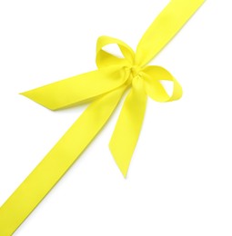 Photo of Yellow ribbon with bow on white background, top view