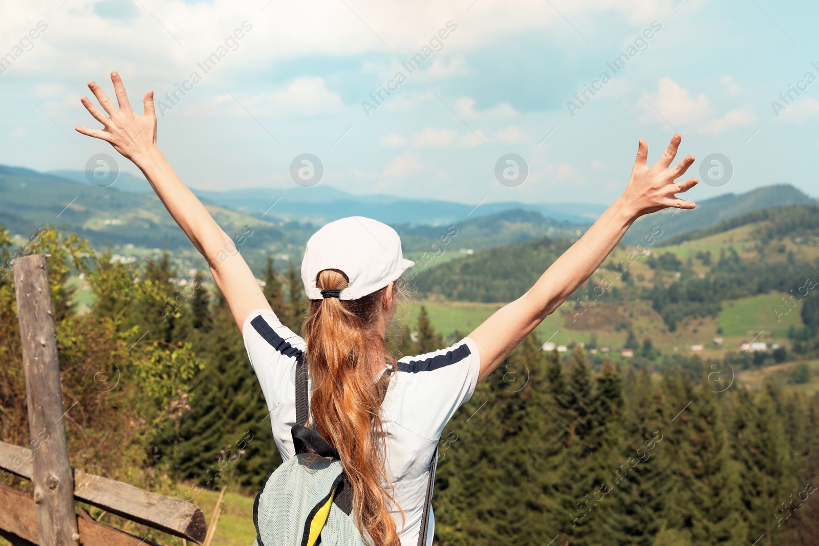 Photo of Woman with backpack in wilderness. Mountain landscape