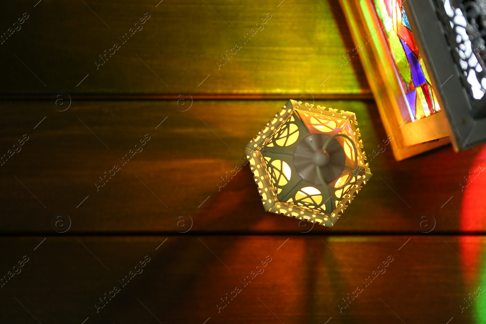 Photo of Decorative Arabic lanterns on wooden table, flat lay. Space for text