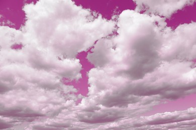 Image of Fluffy clouds floating in beautiful pink sky