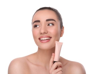 Woman holding tube of foundation on white background