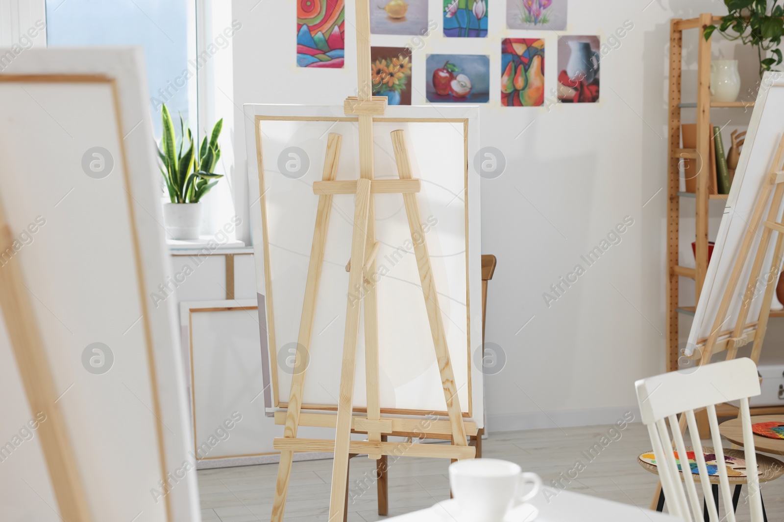 Photo of Stylish artist's studio interior with easels. Creative hobby