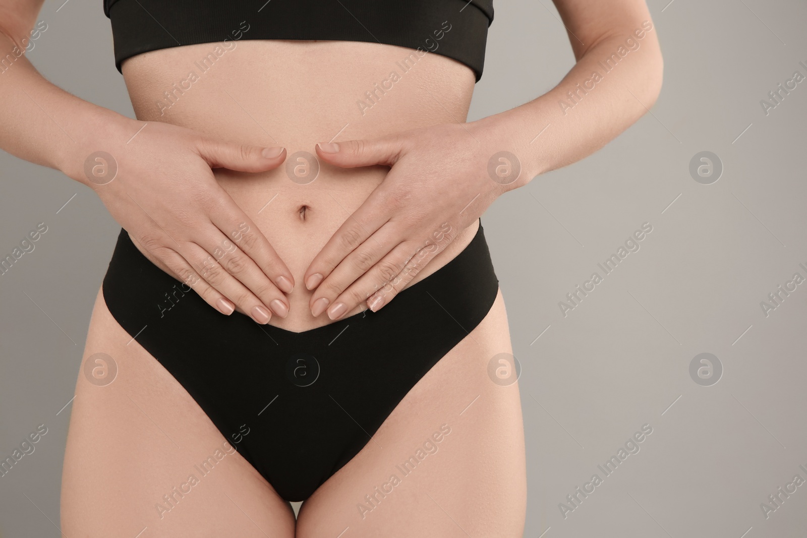 Photo of Gynecology. Woman in underwear on grey background, closeup