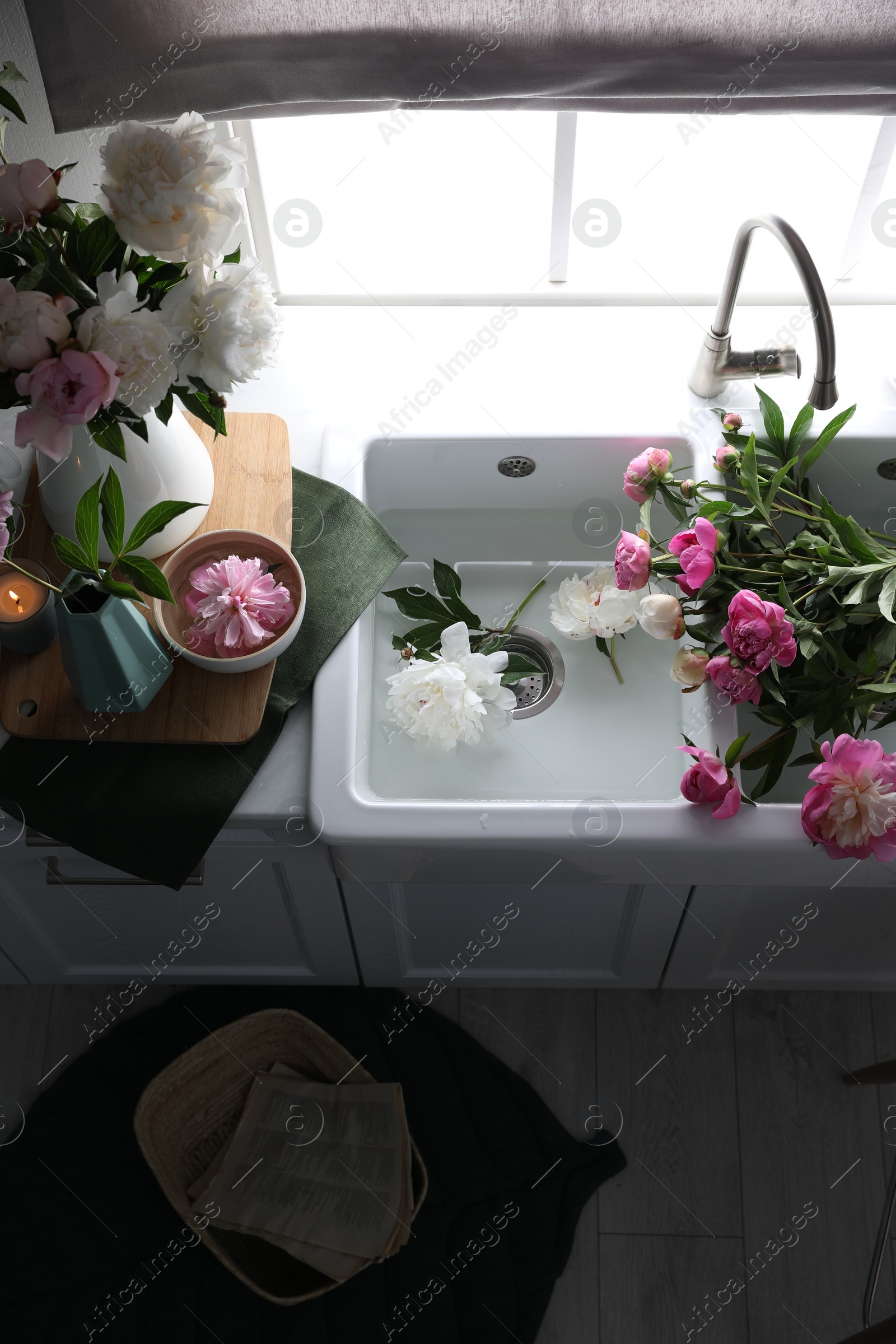 Photo of Beautiful kitchen counter design with fresh peonies, above view