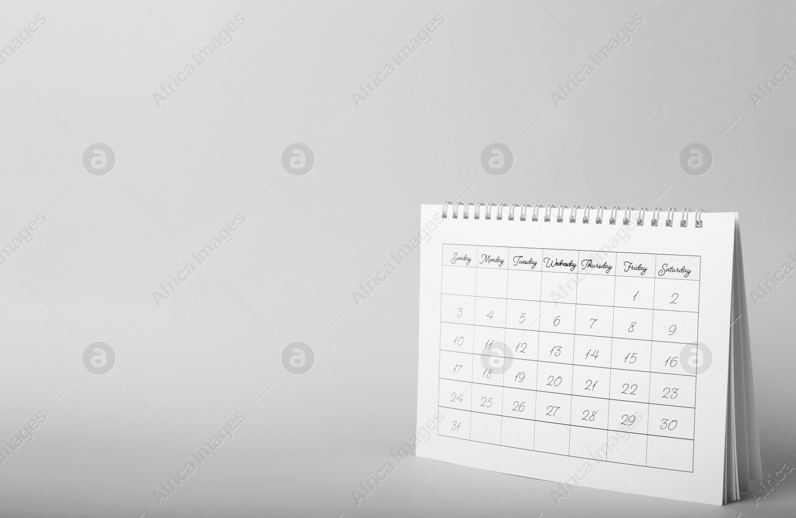 Photo of Paper calendar on grey background, space for text. Planning concept