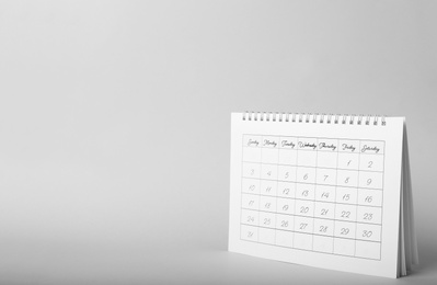 Photo of Paper calendar on grey background, space for text. Planning concept