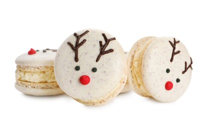 Photo of Delicious Christmas reindeer macarons on white background