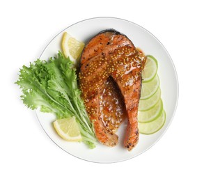 Photo of Tasty salmon steak with sauce, citrus slices and lettuce on white background, top view