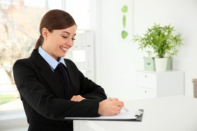 Busy female receptionist at workplace in hotel