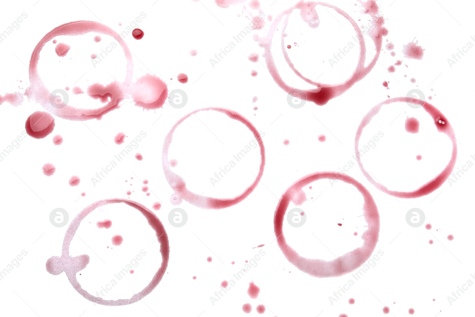 Photo of Red wine rings and drops on white background, top view