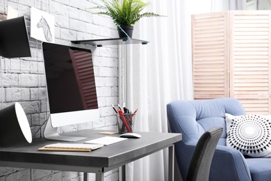 Comfortable workplace with computer on desk in home office