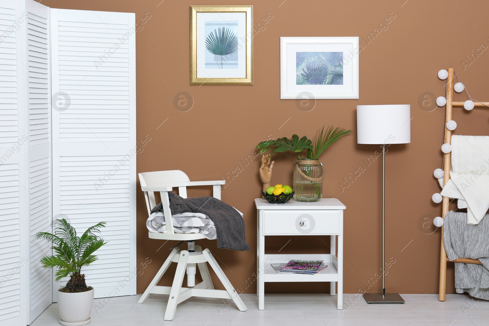 Photo of Stylish room interior with tropical leaves