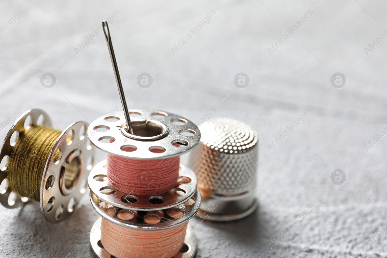 Photo of Set of tailoring accessories on grey background, closeup