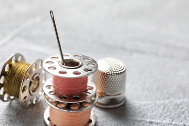 Photo of Set of tailoring accessories on grey background, closeup