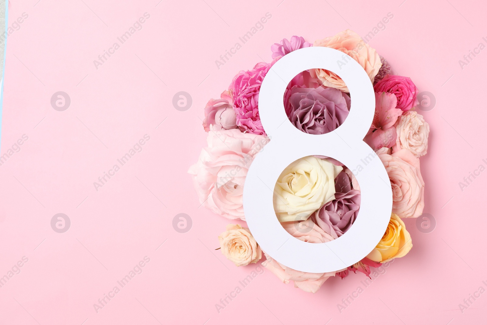 Photo of 8 March greeting card design with beautiful roses on light pink background, top view. Space for text