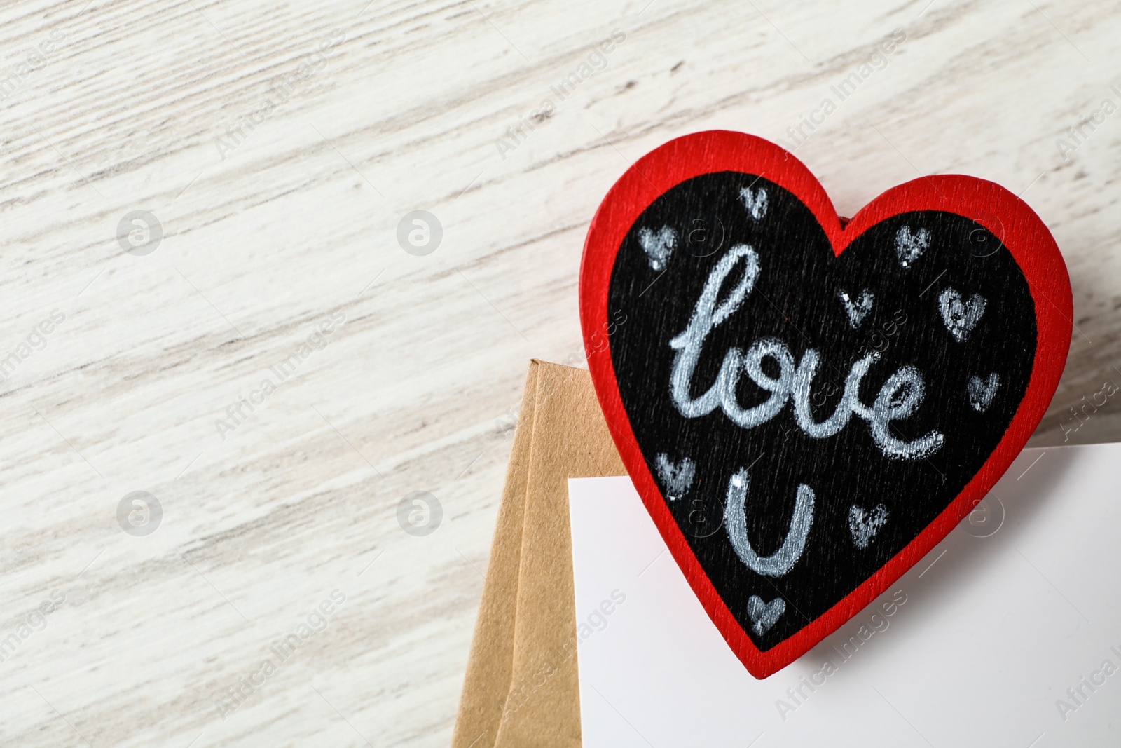 Photo of Heart with words I Love You and envelopes on white wooden background, flat lay. Space for text