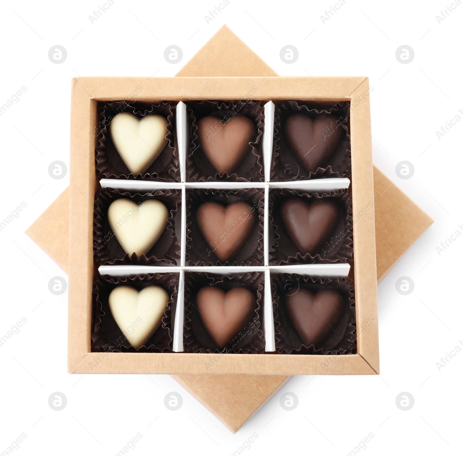 Photo of Tasty heart shaped chocolate candies in box isolated on white, top view. Valentine's day celebration