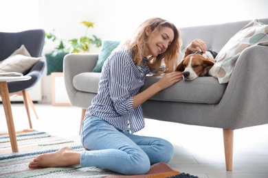 Young woman with her dog at home