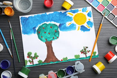 Flat lay composition with child's painting of garden on grey wooden table