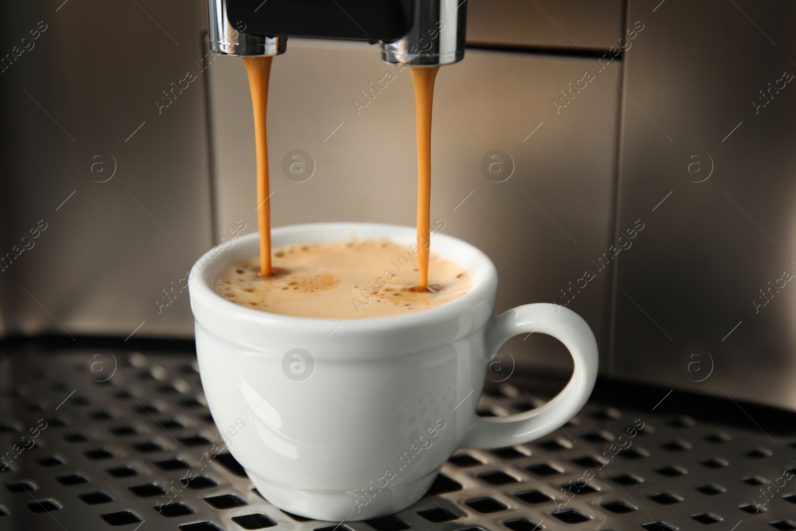 Photo of Espresso machine pouring coffee into cup, closeup