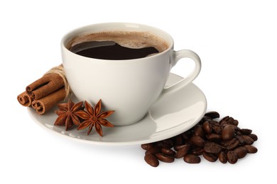 Photo of Cup of aromatic coffee with anise stars, cinnamon sticks and beans on white background