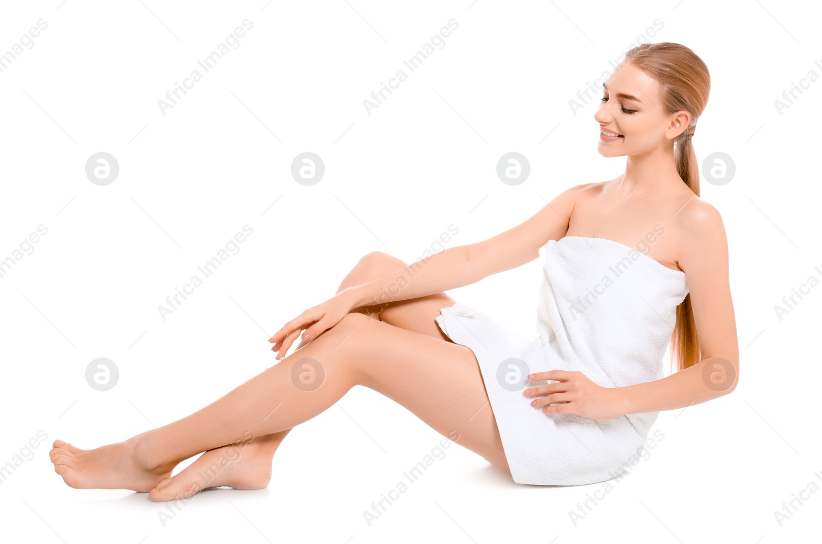 Photo of Young woman applying body cream on white background