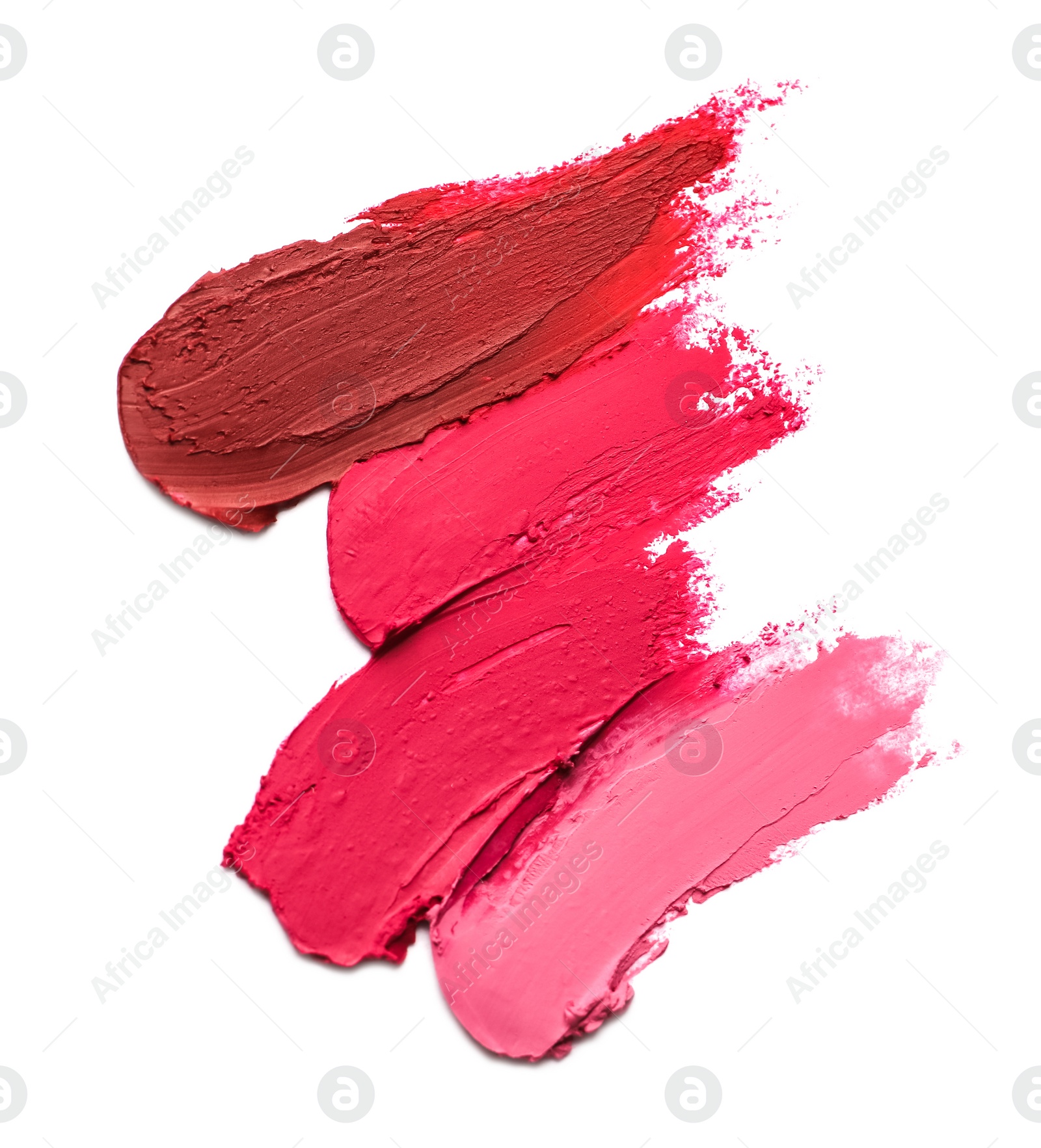 Photo of Smears of bright lipsticks on white background, top view