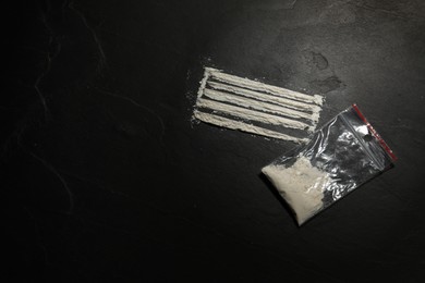 Photo of Plastic bag with hard drug on dark textured background,, flat lay. Space for text