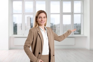 Happy real estate agent showing new apartment