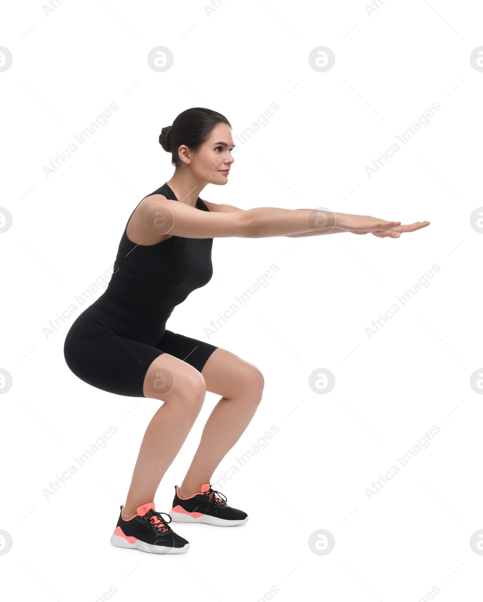 Photo of Woman doing squats on white background. Morning exercise