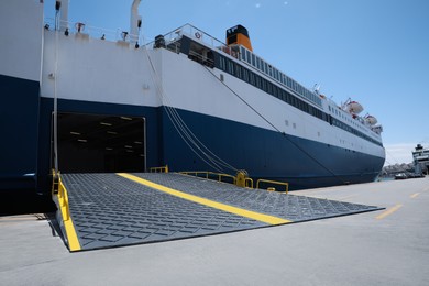 Modern ferry in sea port on sunny day