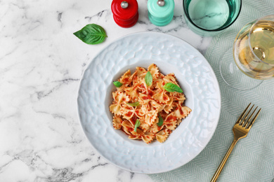 Photo of Flat lay composition with tasty pasta on white marble table