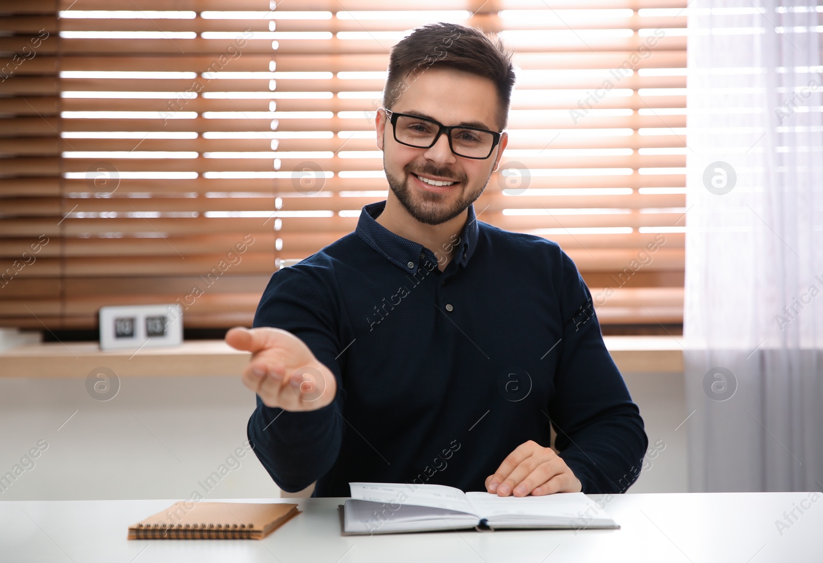 Photo of Happy man using video chat in modern office, view from web camera