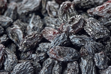 Photo of Tasty raisins as background, closeup. Healthy dried fruit