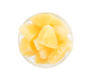 Photo of Pieces of delicious sweet canned pineapple in glass bowl on white background, top view