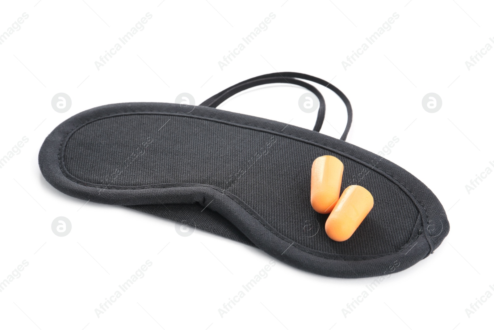 Photo of Pair of ear plugs and black sleeping mask on white background