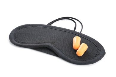 Photo of Pair of ear plugs and black sleeping mask on white background