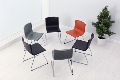 Chairs prepared for group therapy session in office. Meeting room interior