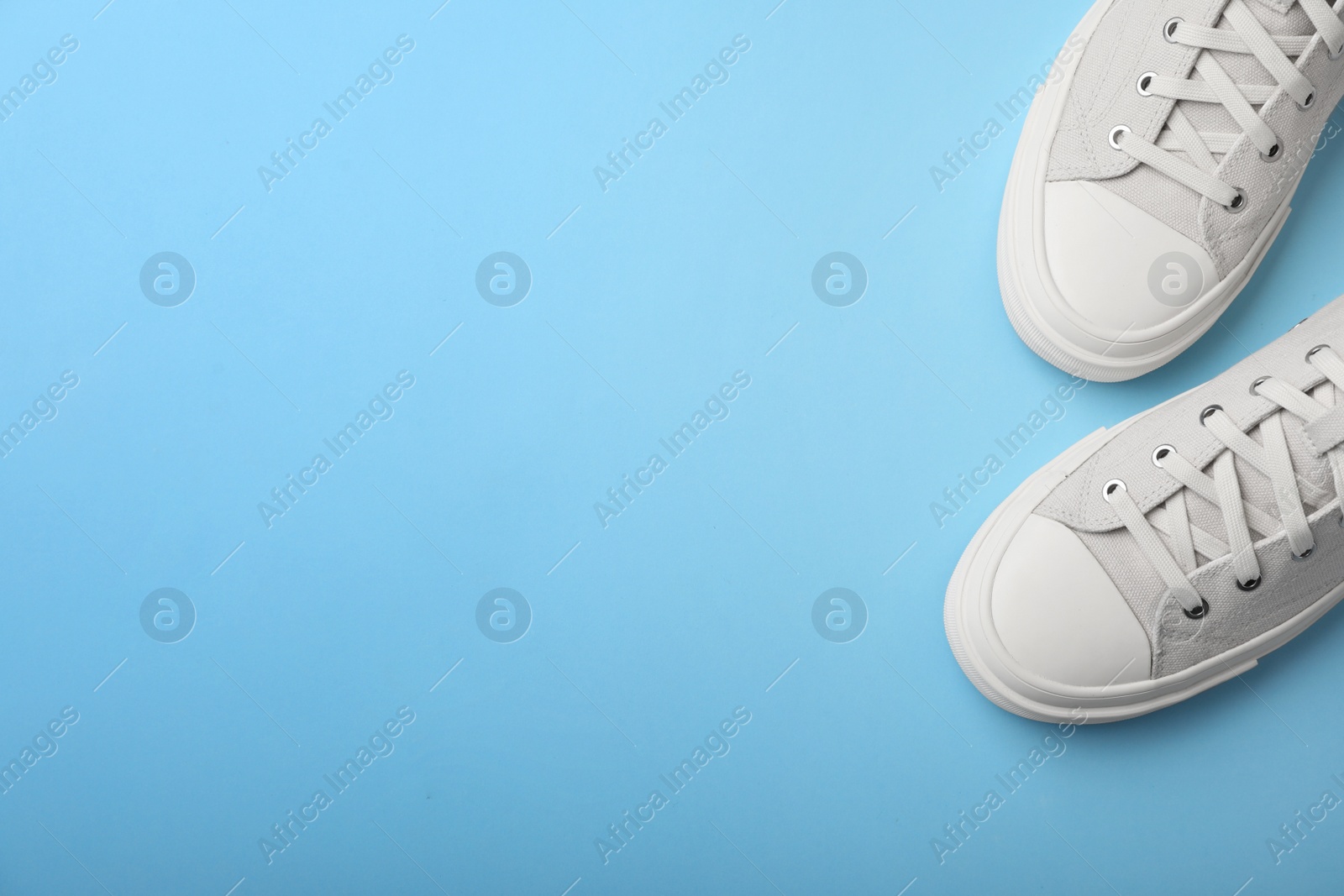 Photo of Pair of sneakers on color background, top view