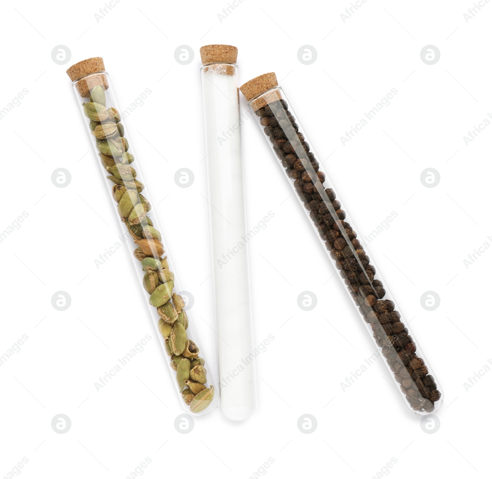 Photo of Glass tubes with cardamom, salt and peppercorns on white background, top view