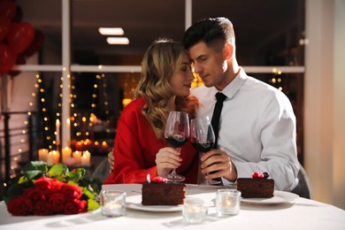 Lovely couple having romantic dinner on Valentine's day in restaurant