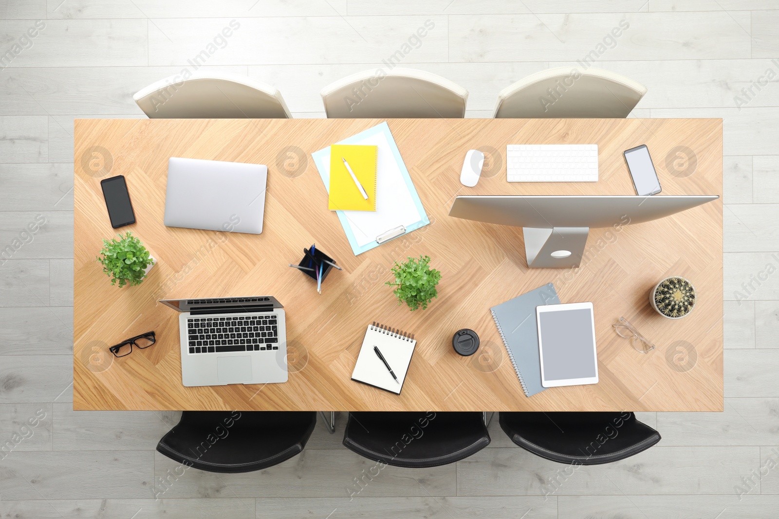 Photo of Modern office table with devices and chairs, top view