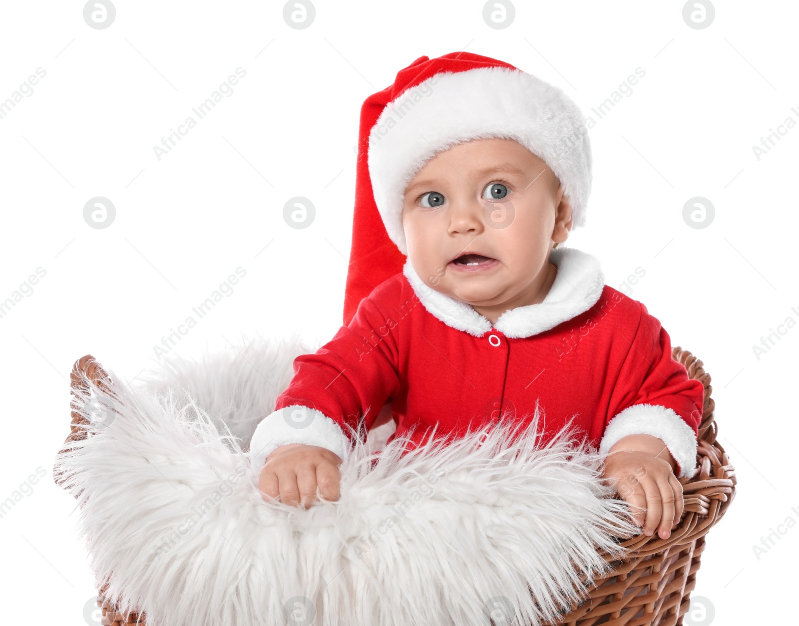 Photo of Cute baby in wicker basket on white background. Christmas celebration