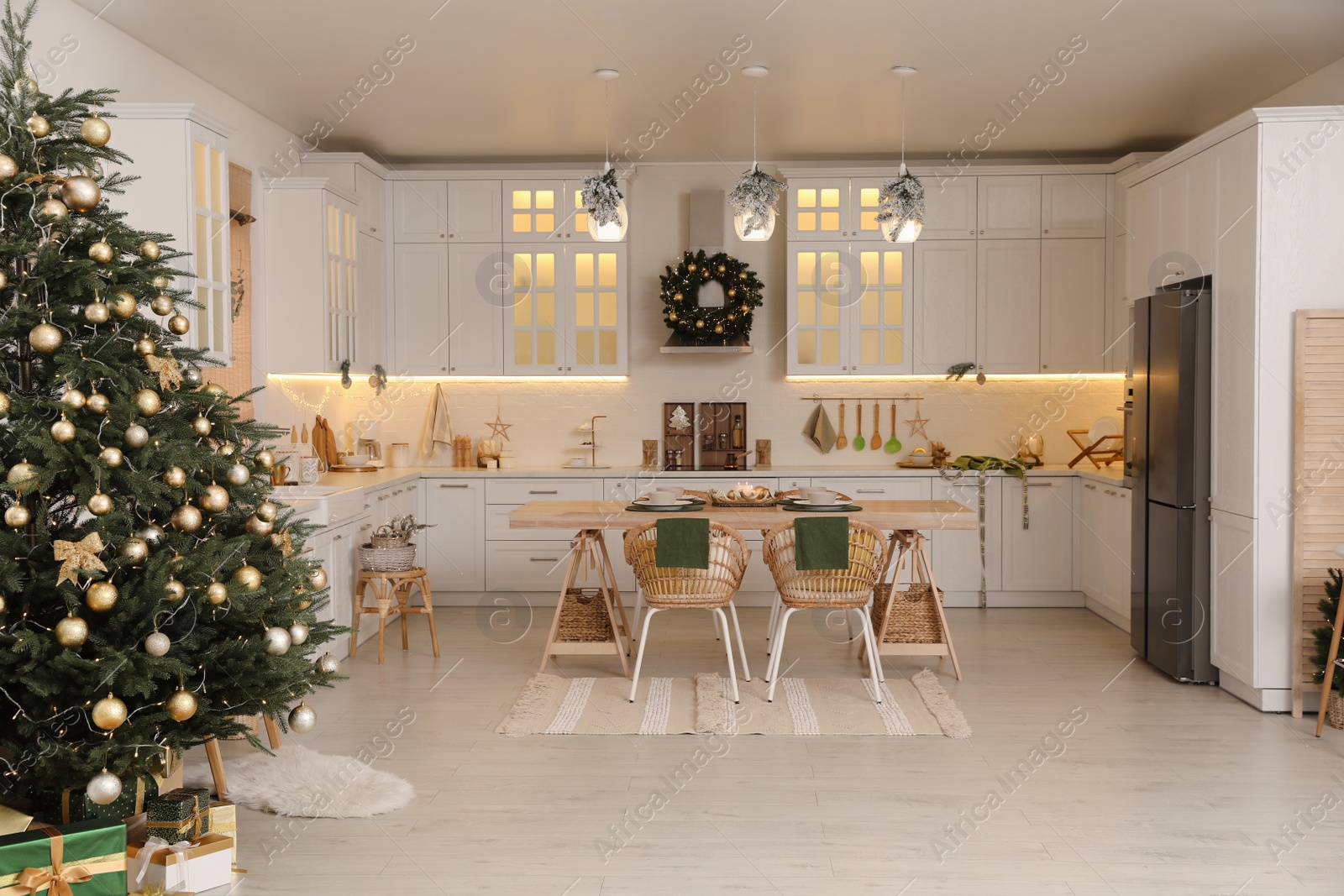 Photo of Cozy open plan kitchen decorated for Christmas. Interior design