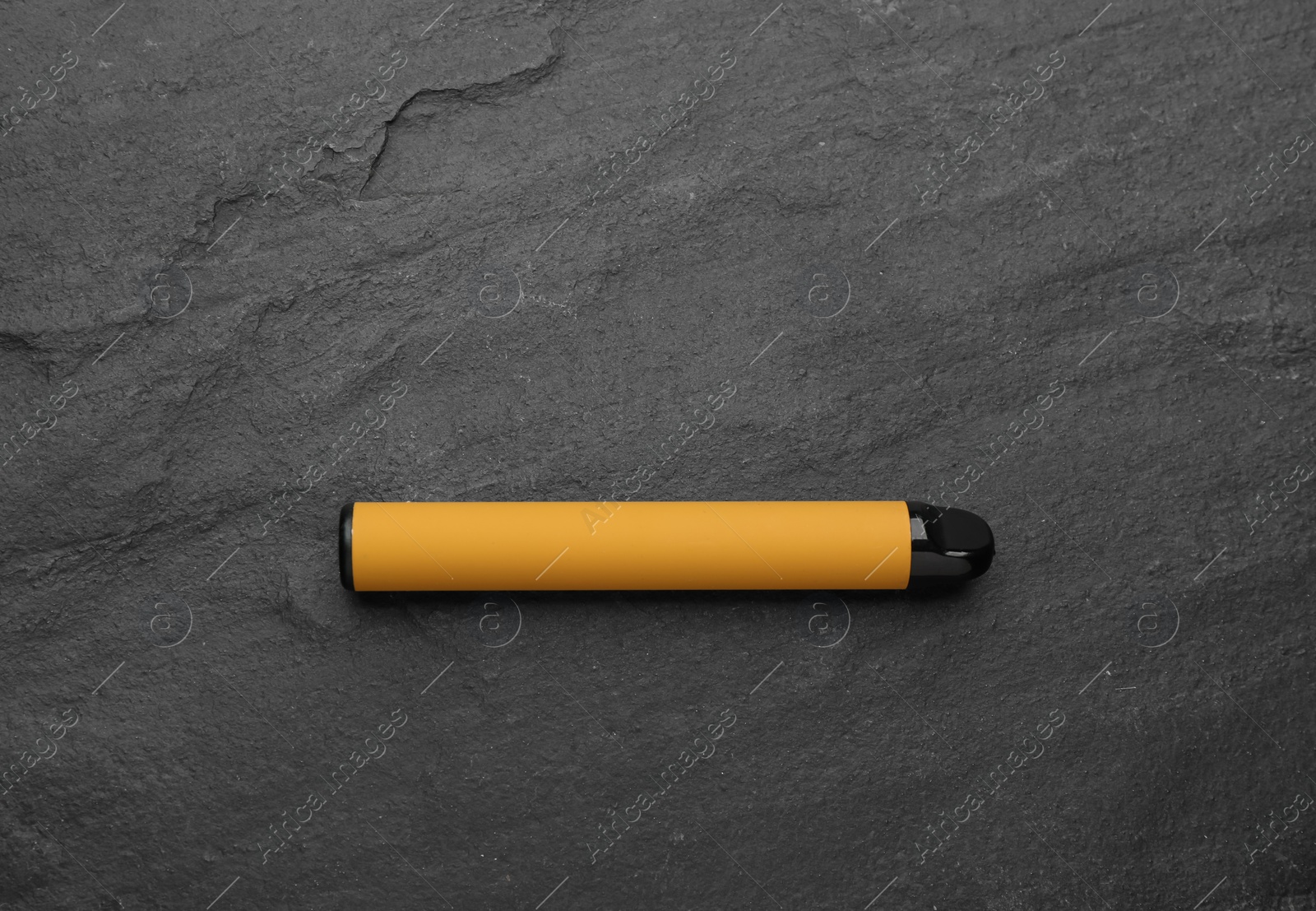 Photo of Disposable electronic smoking device on black background, top view
