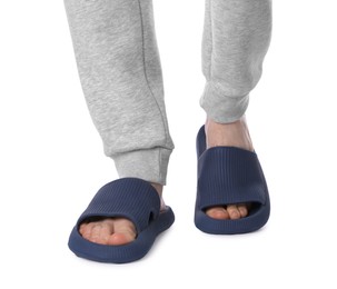 Man in blue slippers on white background, closeup