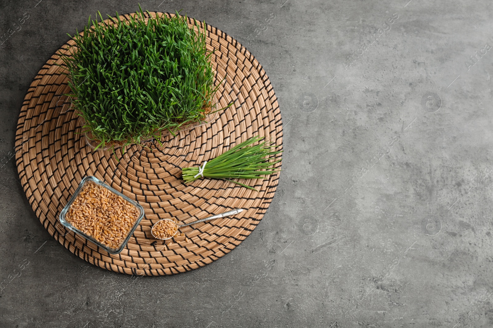 Photo of Flat lay composition with green wheat grass on table, space for text