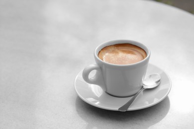 Ceramic cup of aromatic coffee on table in morning, space for text